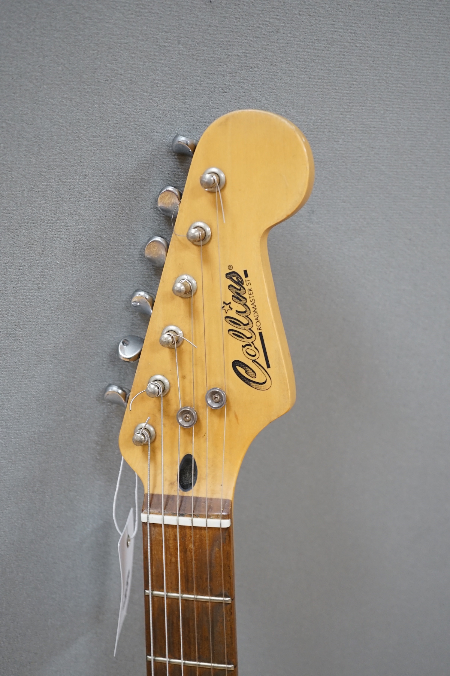 A Collins Sunburst electric guitar with hard flight case